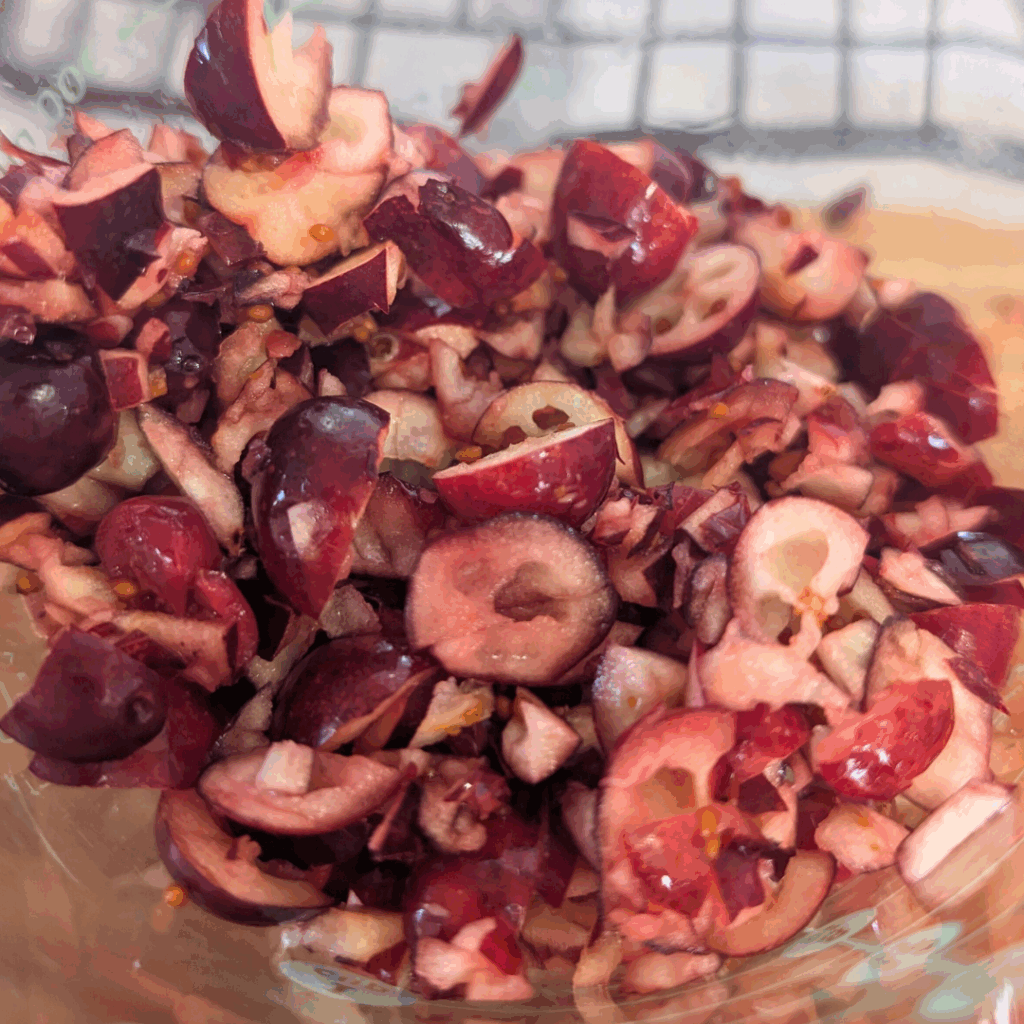 Sliced fresh cherries and fruit pieces for cooking or baking.