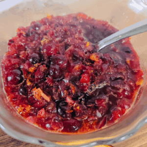 Fresh homemade cherry compote in a glass bowl for cooking or baking.