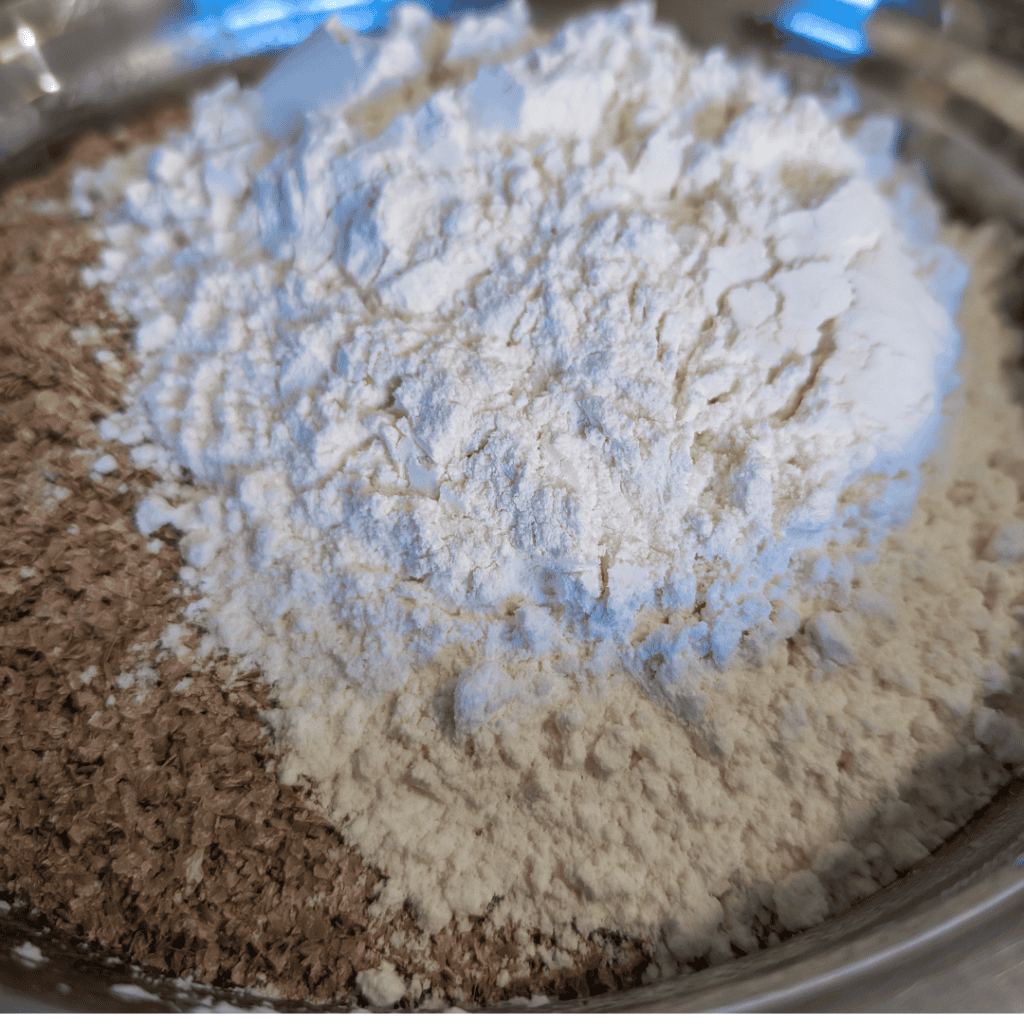 Close-up of white flour and wheat bran in a mixing bowl.