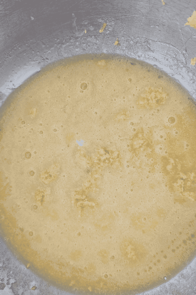Blueberry muffin batter with frozen Canadian wild blueberries in mixing bowl.
