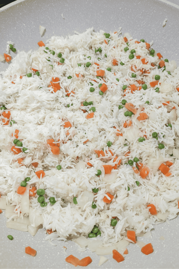 Delicious shrimp fried rice with eggs, peas, and carrots, perfect for quick weeknight dinners. Easy.