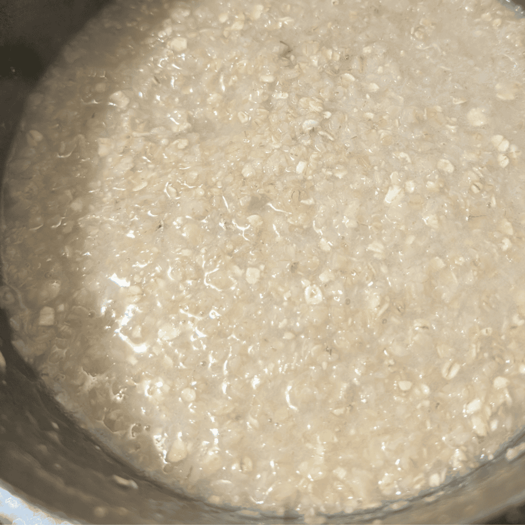 Old-fashioned oats in a white bowl for healthy breakfast.