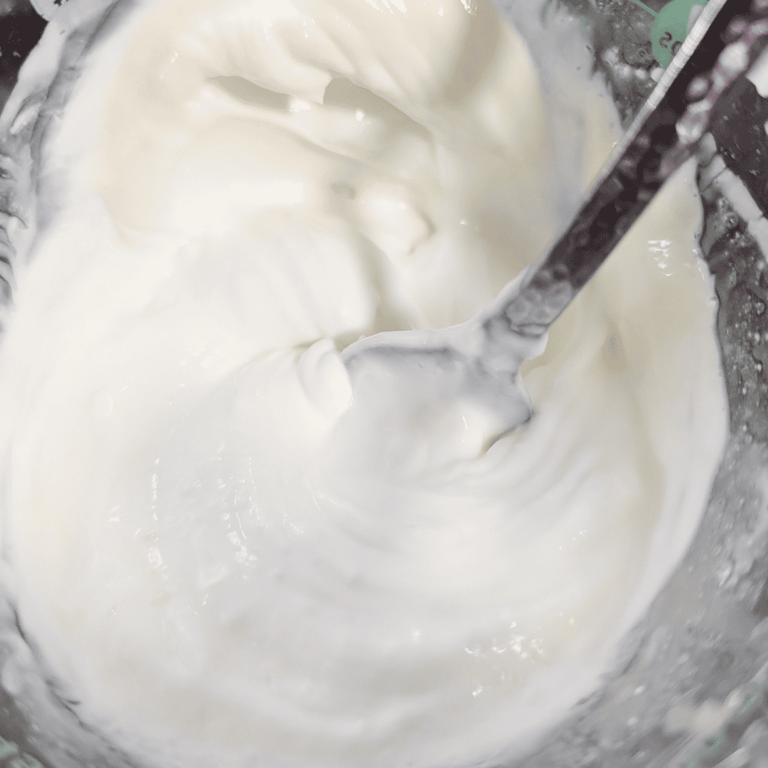 Smooth Greek yogurt dressing in a bowl, perfect for chicken couscous salad.