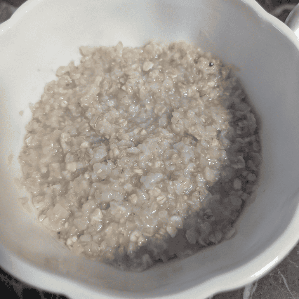 Creamy banana walnut oatmeal served in a white bowl, perfect for a healthy breakfast.