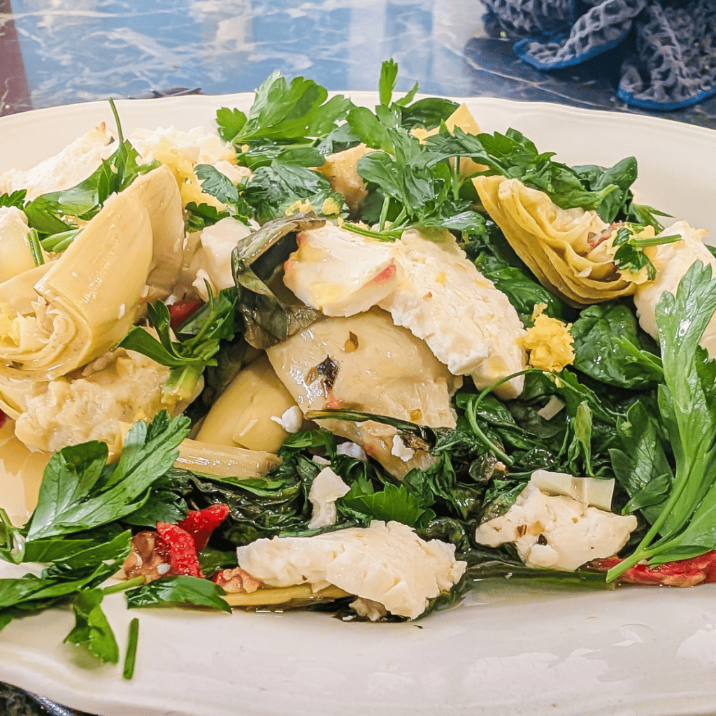 Delicious spinach artichoke casserole with feta cheese and sun-dried tomatoes, perfect for a flavorf.