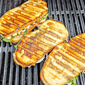 Delicious grilled chicken sandwiches with fresh greens on toasted bread, perfect for lunch or dinner.