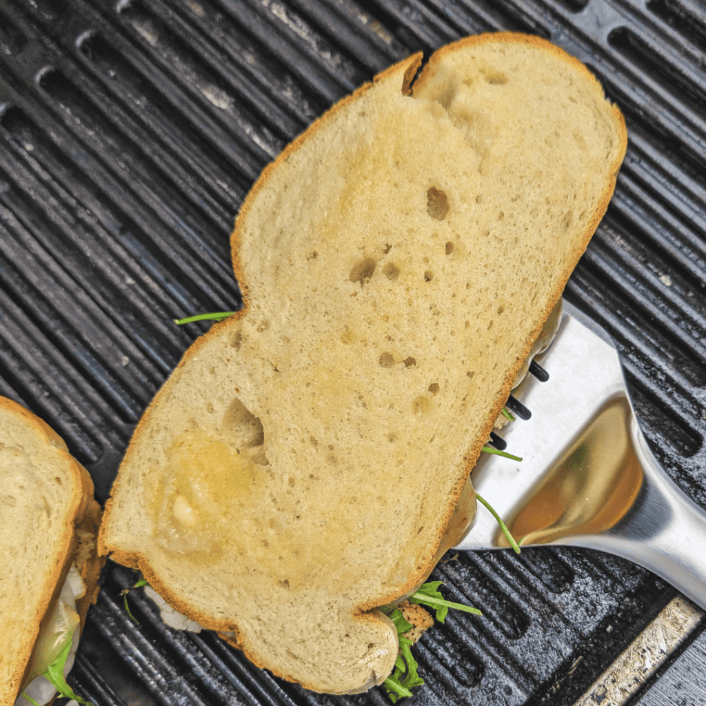 Garlic bread slice on a grill pan, perfect for homemade recipes and flavorful meals.