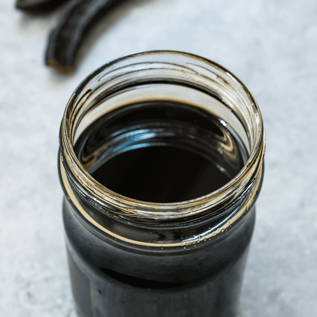 Black coffee in a glass jar, perfect for breakfast or a morning boost.