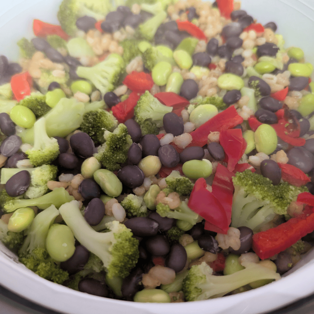 Broccoli, edamame, red bell peppers, and black beans in a fresh vegetable salad. Healthy, colorful,.