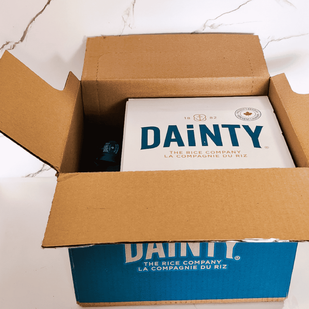 Dainty rice box inside a cardboard shipping box, ready for delivery.