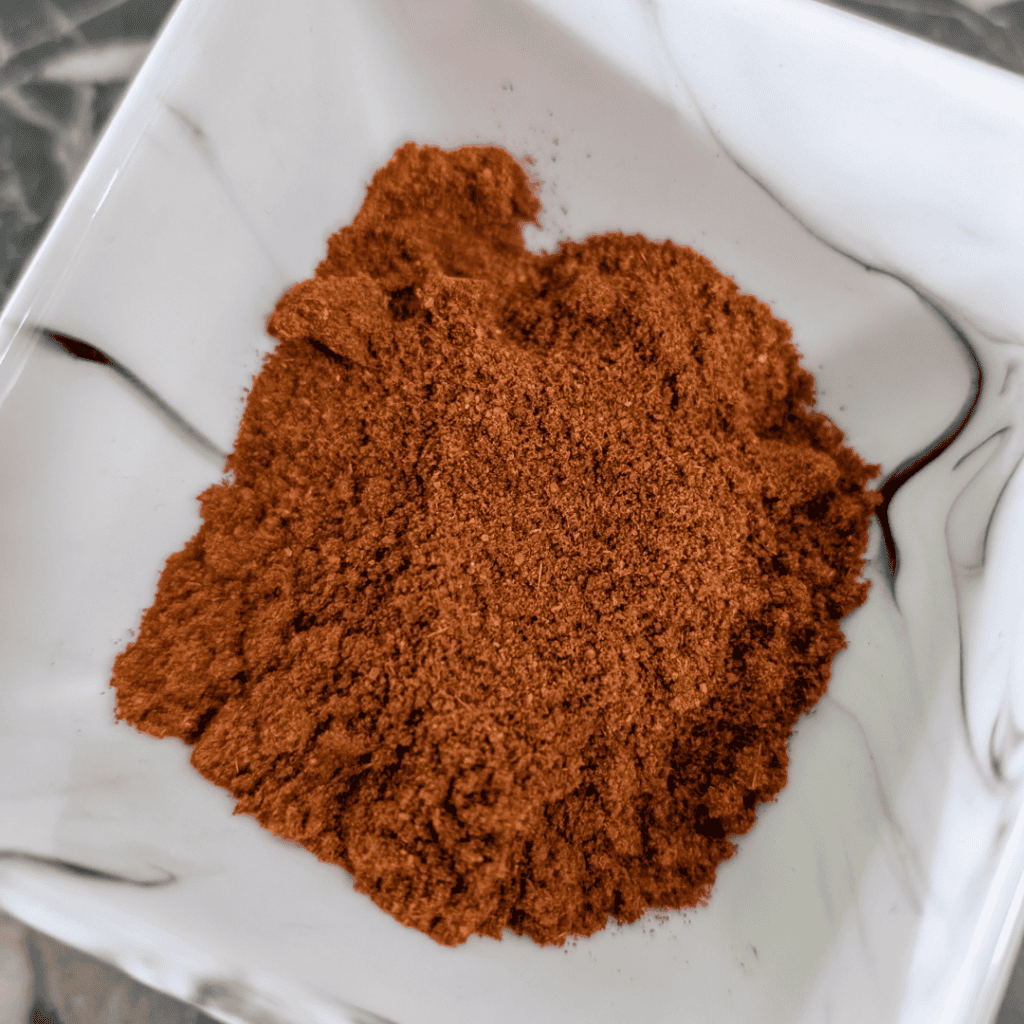 Close-up of homemade taco seasoning in a white bowl for flavorful tacos.