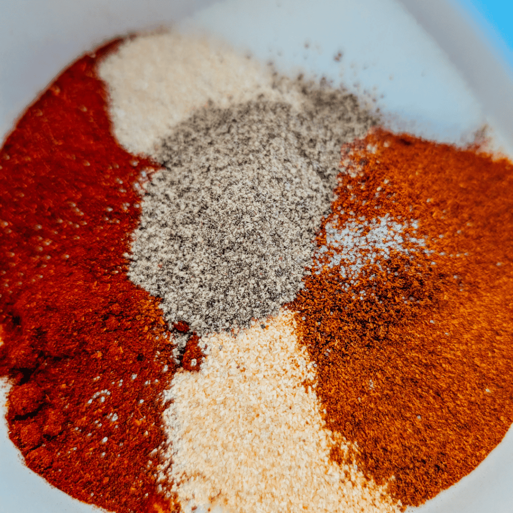 Assorted spices for BBQ chicken with smoky flavor.