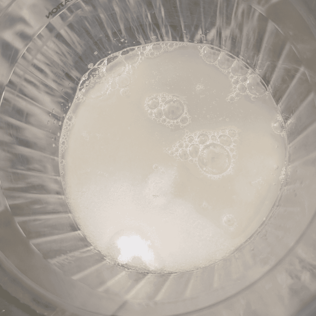 Creamy milk in a glass for cooking or baking, ideal for recipes and culinary uses.