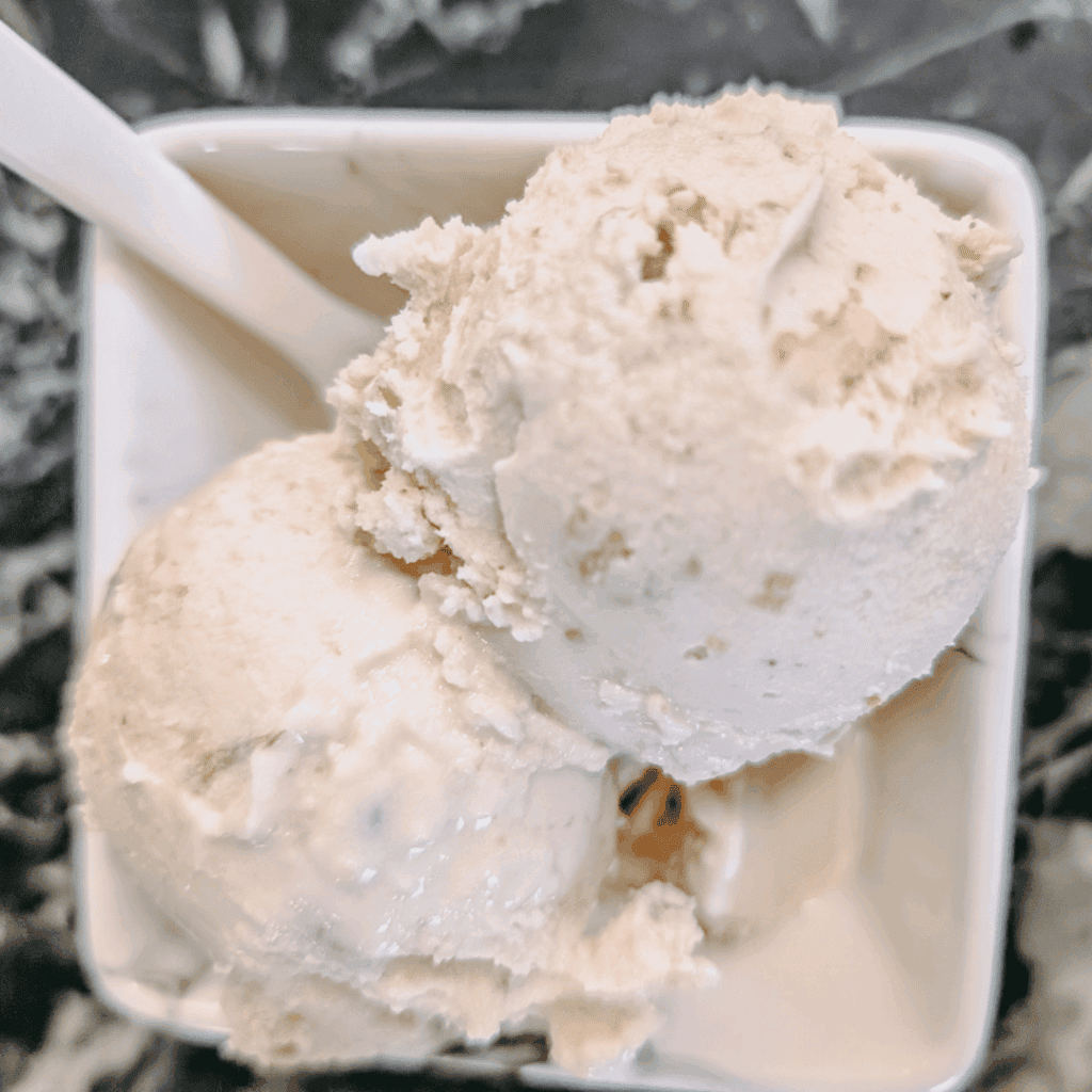 Delicious vanilla ice cream scoops served in a white bowl, ideal for cooling treats.