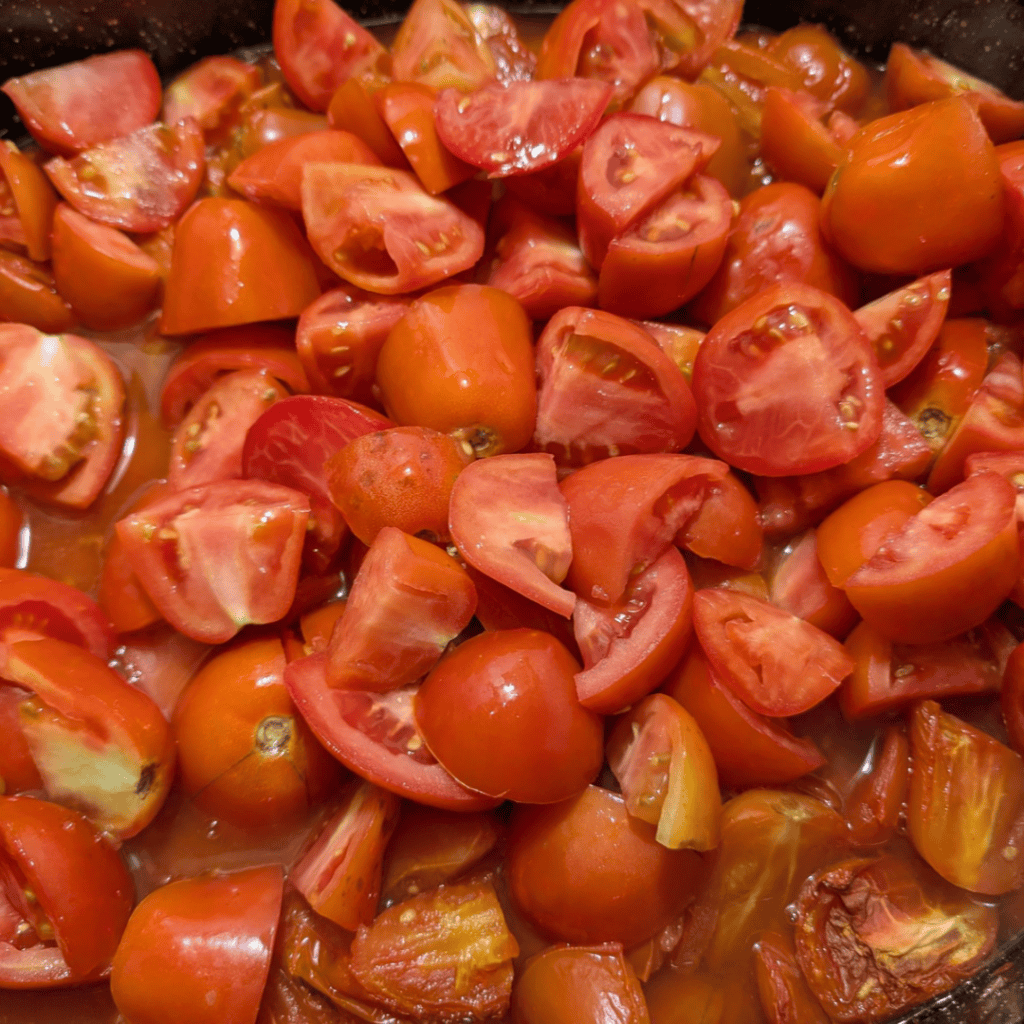Fresh cherry tomatoes chopped for homemade tomato sauce.