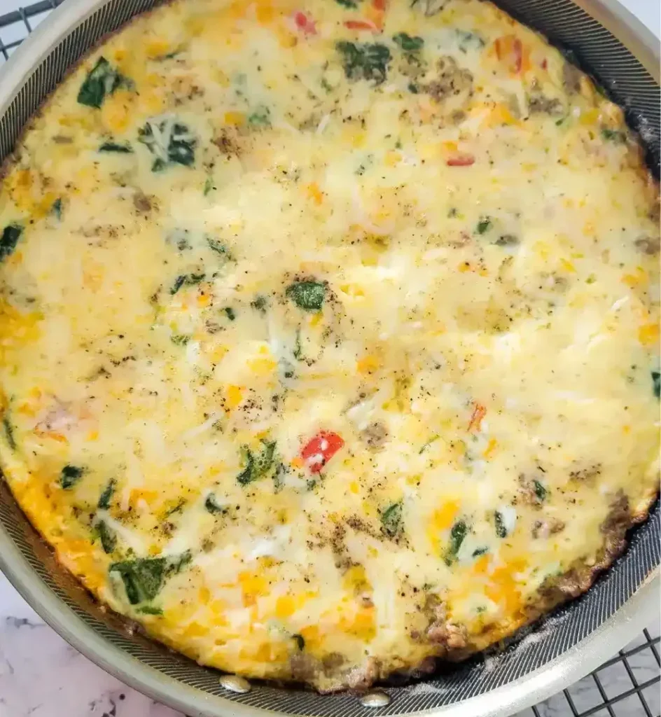 the finished baked frittata cooling on wire rack on white marble