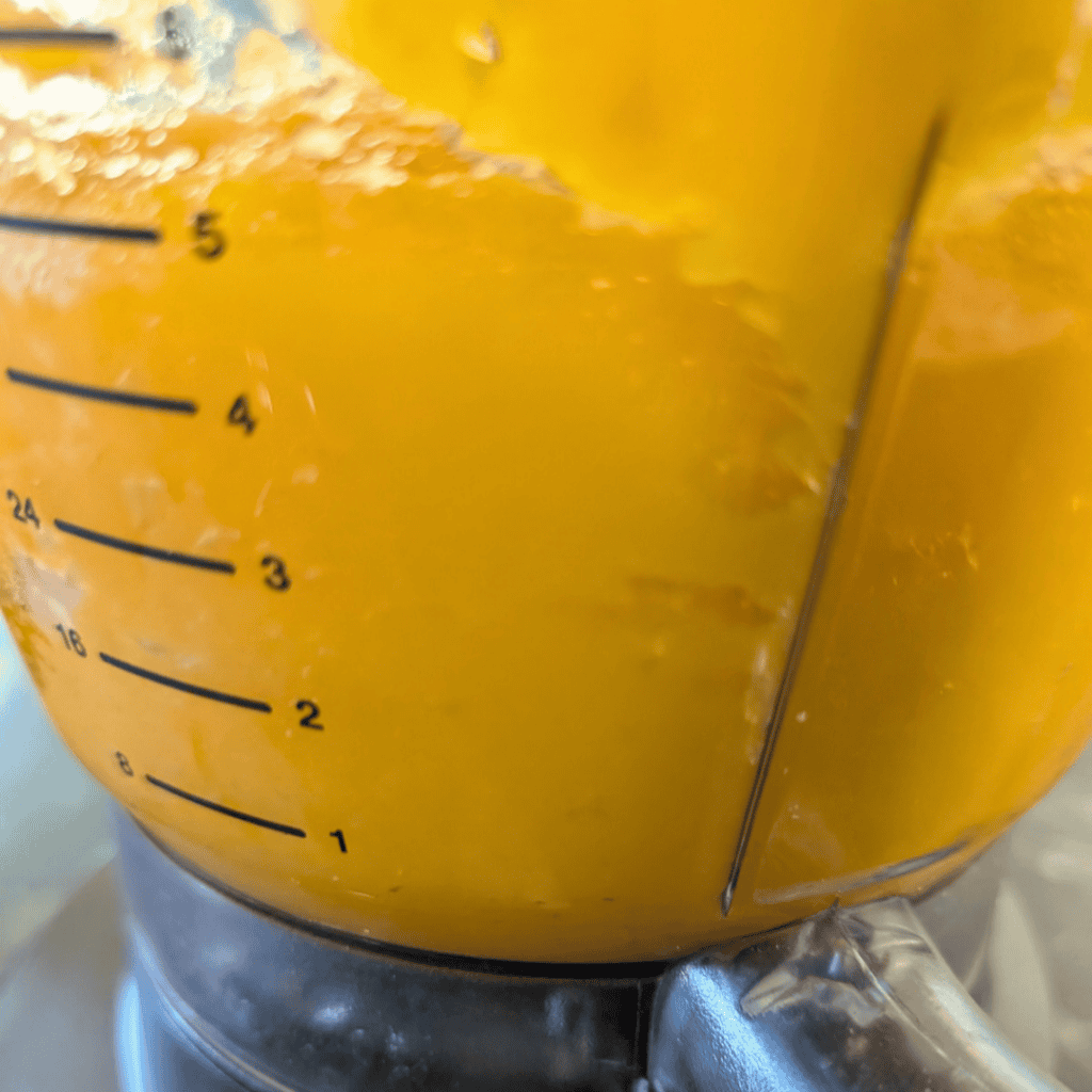 side of food processor with pumpkin puree