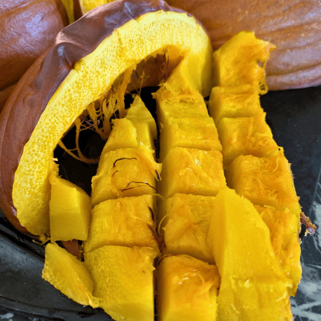 cut up peeled roasted pumpkin next to roast pumpkin wedge