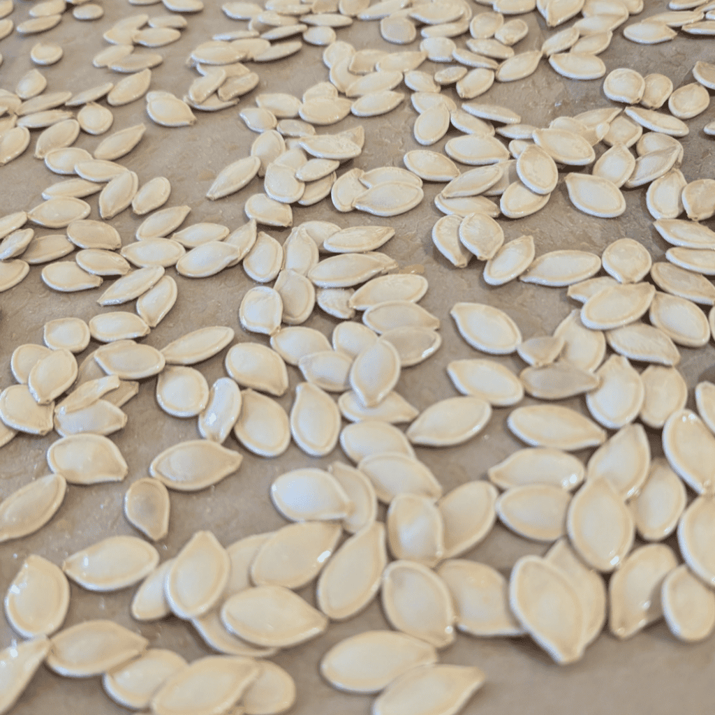 pumpkin seeds on baking sheet spread out