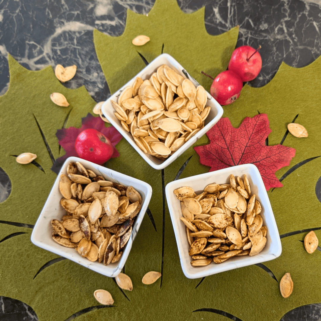roast pumpkin seeds on felt leaf placemat with crabapples and seeds scattered around