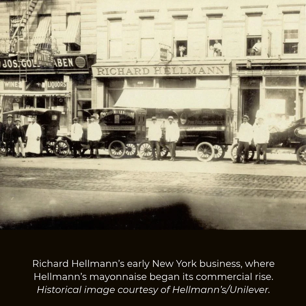 Historic Richard Hellmann delicatessen in New York with employees and early delivery vehicles outside.