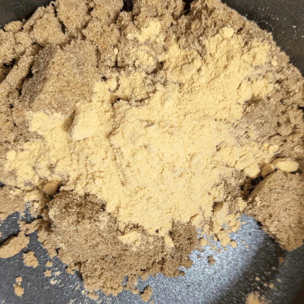 brown sugar and mustard powder in saucepan