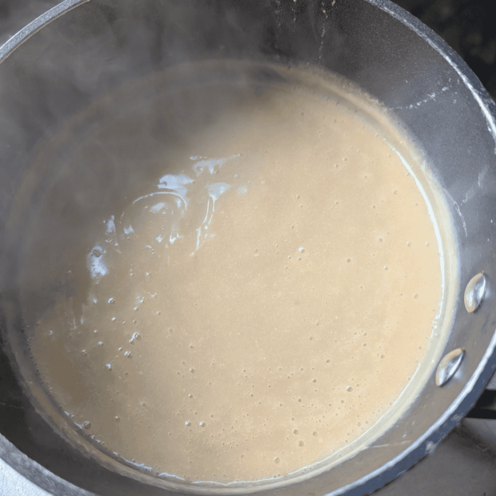the finished cooked brown mayonnaise off of heat in saucepan steaming