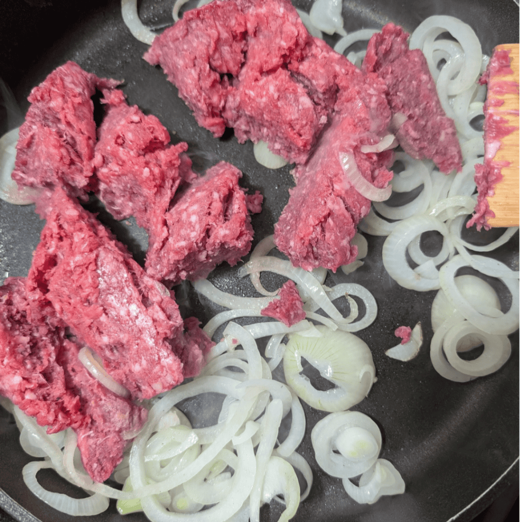 adding beef with onion