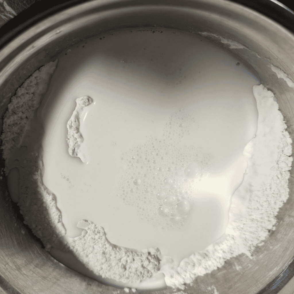 Milk and flour mixture in a mixing bowl for turkey and dumplings recipe.