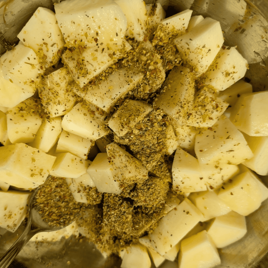 adding spice to cubed potatoes (1)