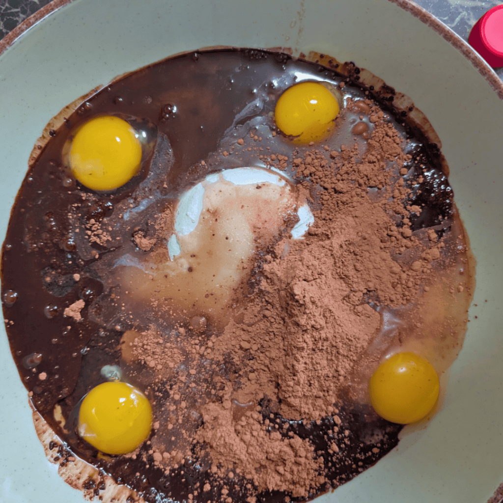 adding the eggs cocoa sugar in bowl