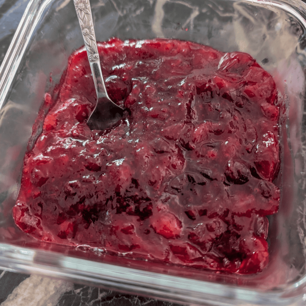 cranberry sauce in glass dish with spoon