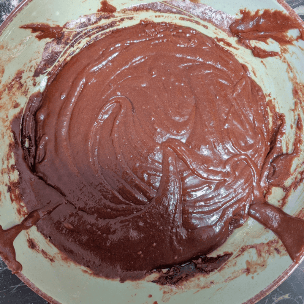 cutting cooled brownies with cocoa powder (2) in bowl