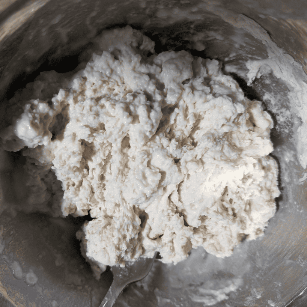 Close-up of homemade dumpling dough in mixing bowl for turkey recipe.