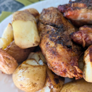 roasted chicken and potatoes close up on plate