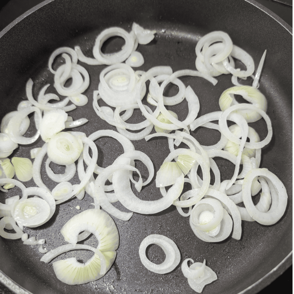 softening onion sliced in frying pan