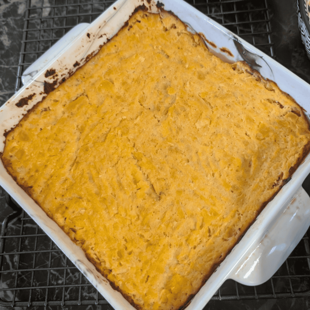 Baked turnip and rutabaga puff in a white dish, golden crust on top.