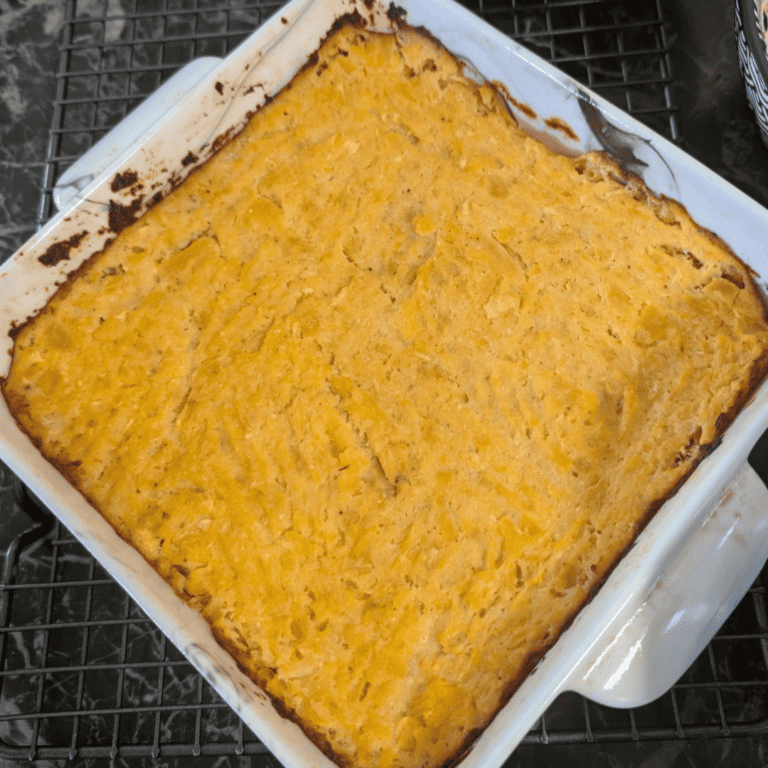 Baked turnip and rutabaga puff in a white dish, golden crust on top.