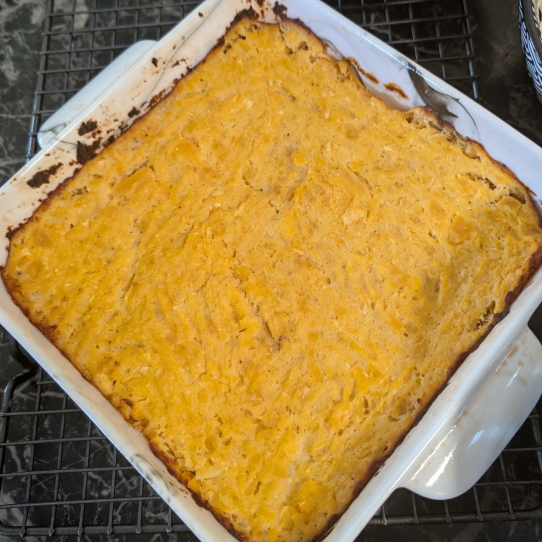 Baked turnip and rutabaga puff in a white dish, golden crust on top.