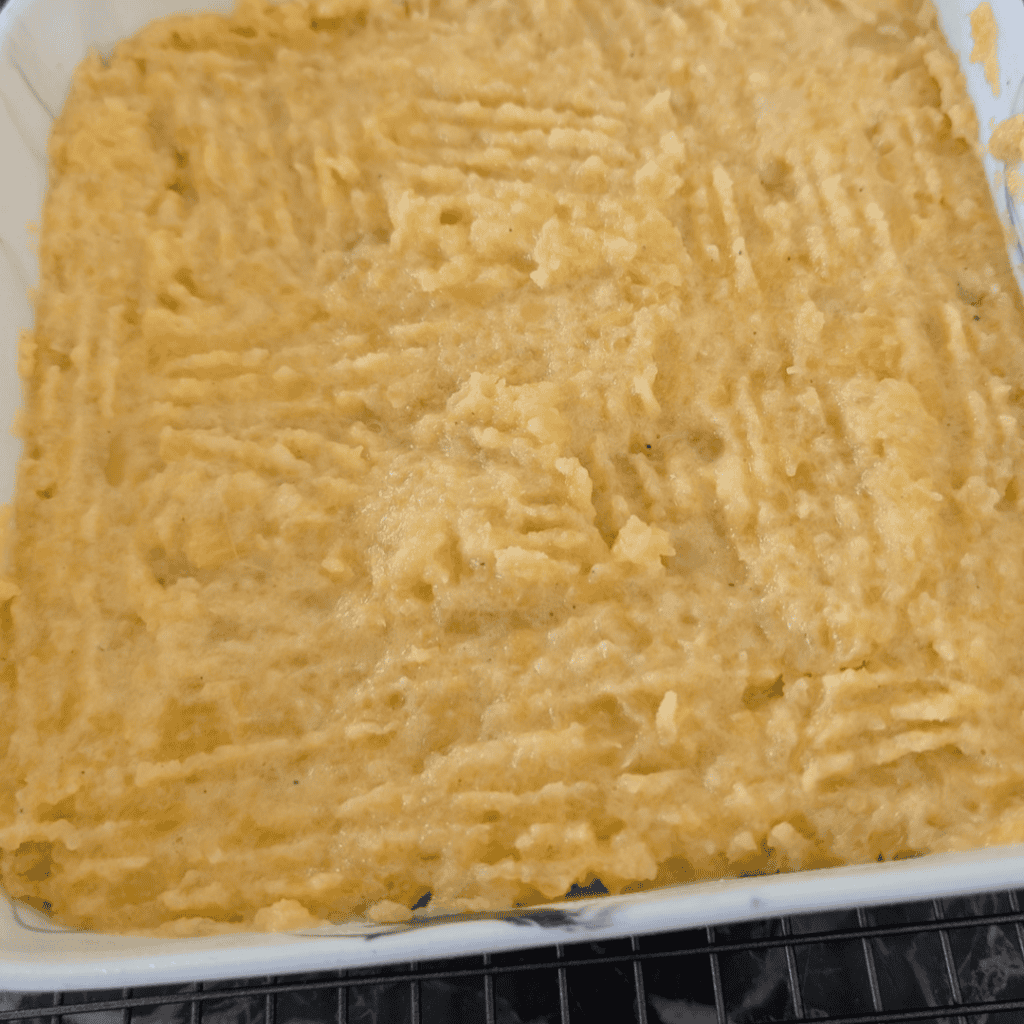 Close-up of a baked turnip and rutabaga puff in a baking dish.