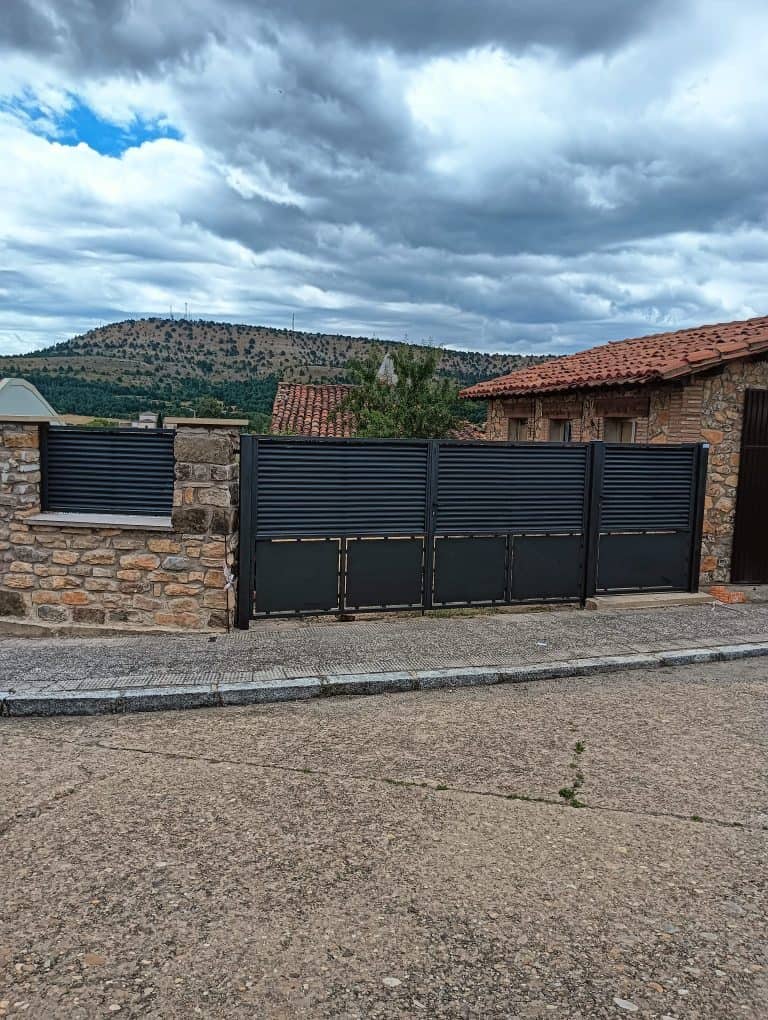 Puerta de hierro para seguridad y privacidad en accesos residenciales.