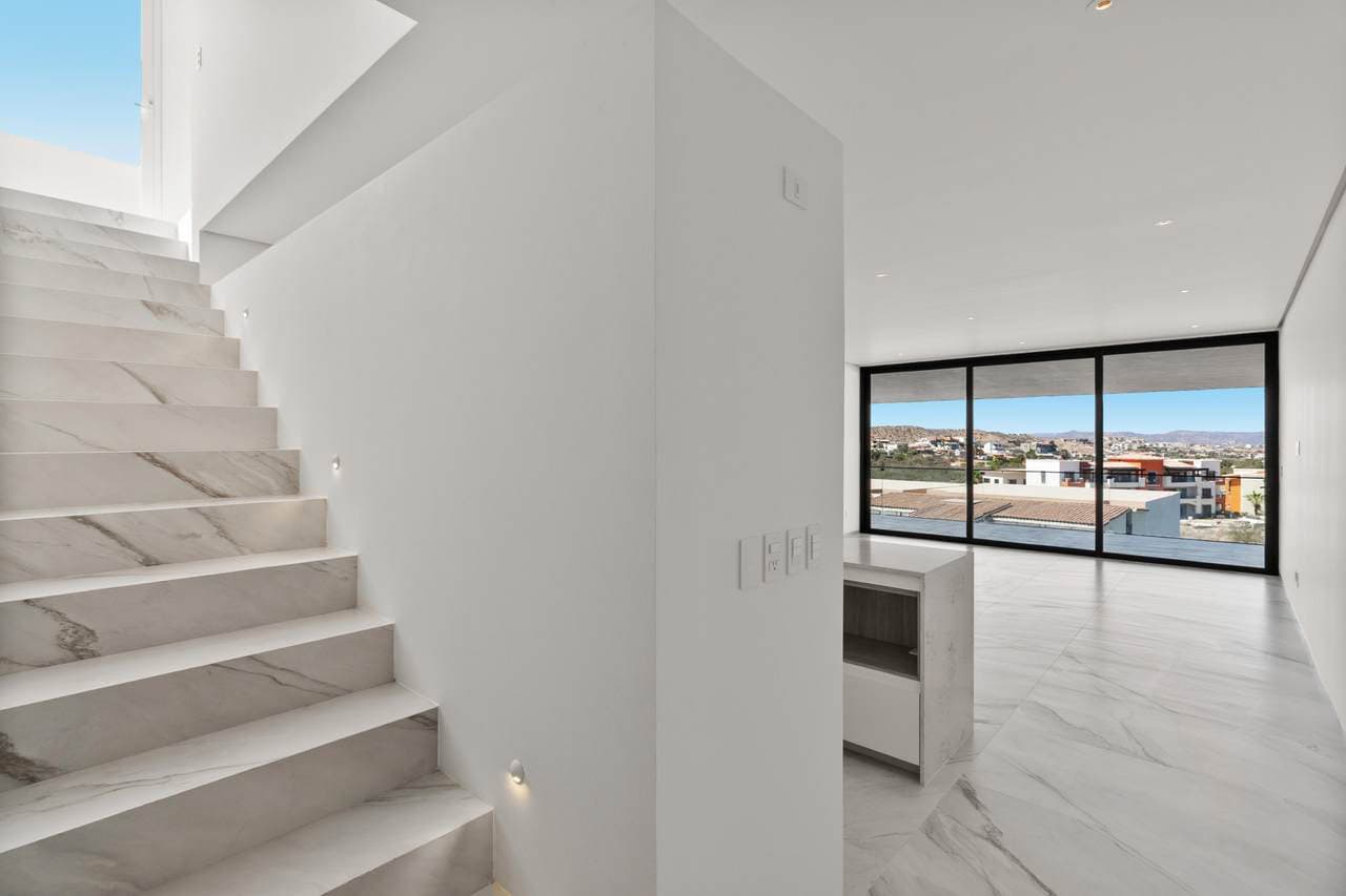 Modern Interior With Large Glass Windows Overlooking Ocean View And Surrounding Landscape, Perfect For Luxury Coastal Living At Club Campestre.