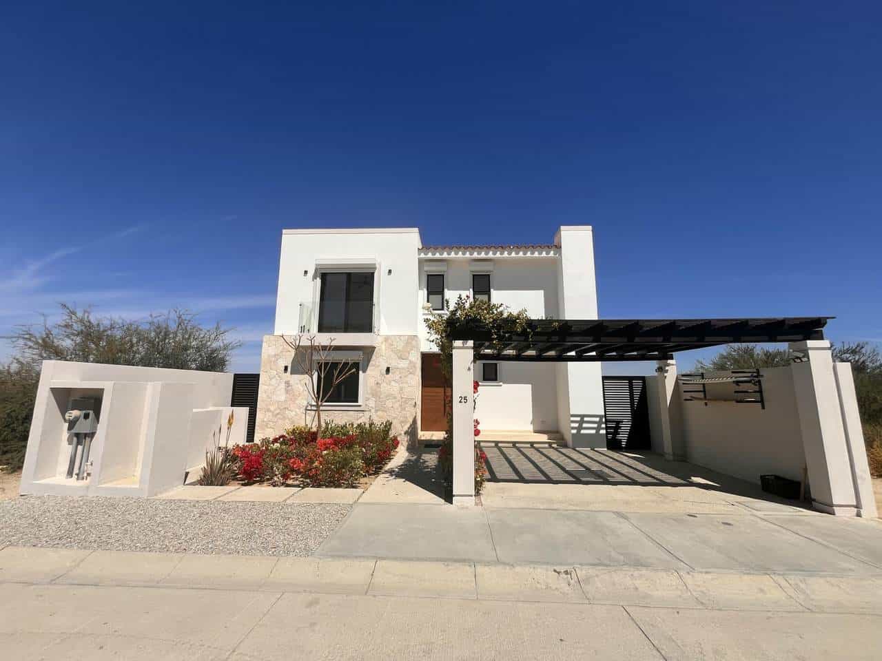 Modern White House With Ocean View, Surrounded By Landscaped Garden And Clear Blue Sky At Club Campestre Real Estate.