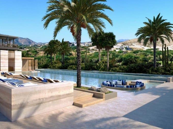 Luxurious Pool Area With Ocean View, Palm Trees, And Mountain Scenery At Club Campestre Real Estate. Perfect For Relaxing Amidst Lush Greenery, Golf Course, And Stunning Coastal Vistas.