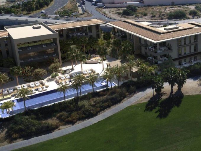 Luxury Golf Course And Ocean View Residential Complex At Club Campestre, Modern Apartments With Scenic Golf Course And Ocean Vistas, Perfect For Upscale Living And Relaxation, Sunny Outdoor Pool And Lush Landscape, Golf Course And Ocean In Background, Contemporary Architecture And Outdoor Amenities, Ideal For Real Estate Investment And Leisure.