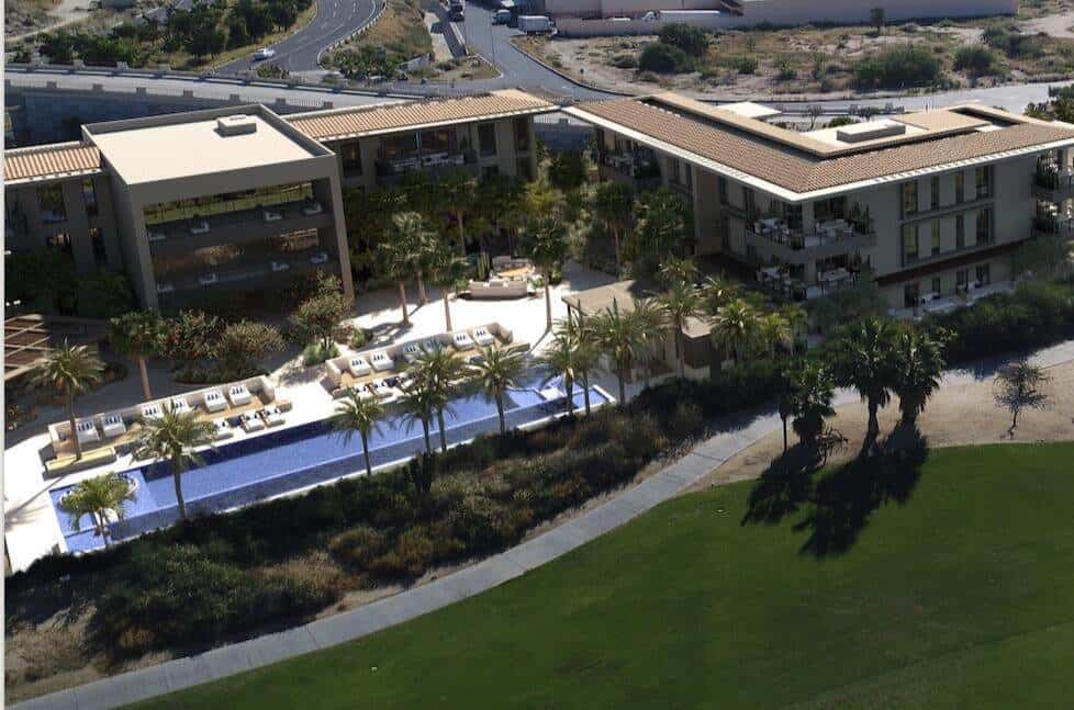 Luxury Golf Course And Ocean View Residential Complex At Club Campestre, Modern Apartments With Scenic Golf Course And Ocean Vistas, Perfect For Upscale Living And Relaxation, Sunny Outdoor Pool And Lush Landscape, Golf Course And Ocean In Background, Contemporary Architecture And Outdoor Amenities, Ideal For Real Estate Investment And Leisure.