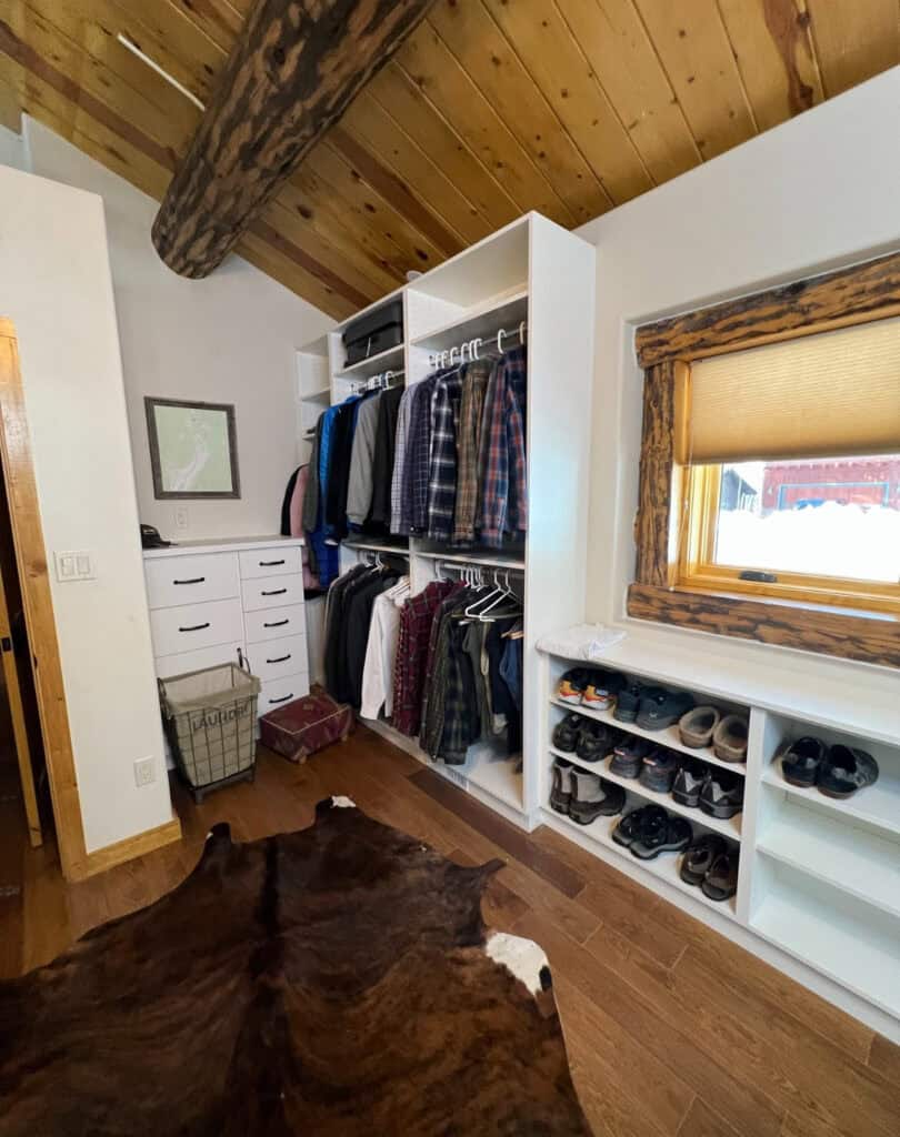 Custom closet with organized clothing and shoe storage in Durango home.