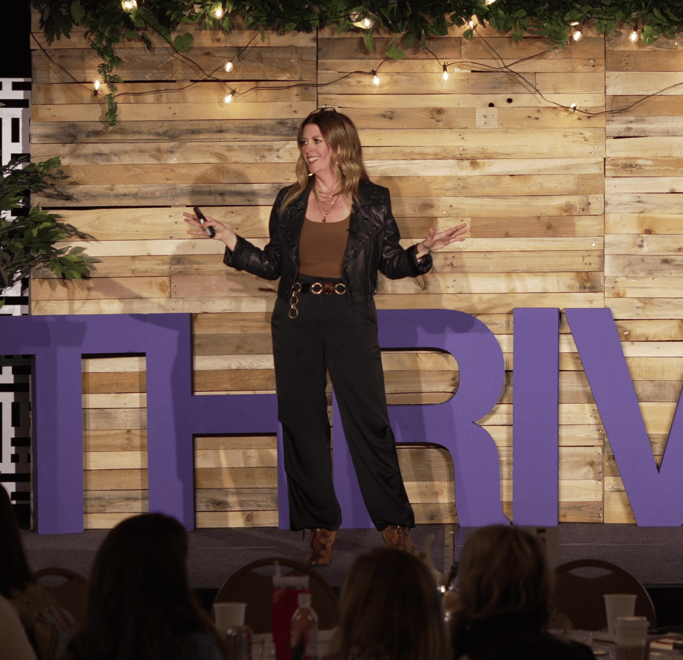 Shelley Paxton speaking on stage at a THRIVE event