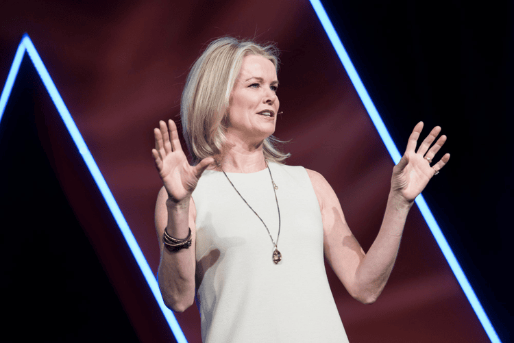 Katty Kay speaking on stage at a conference
