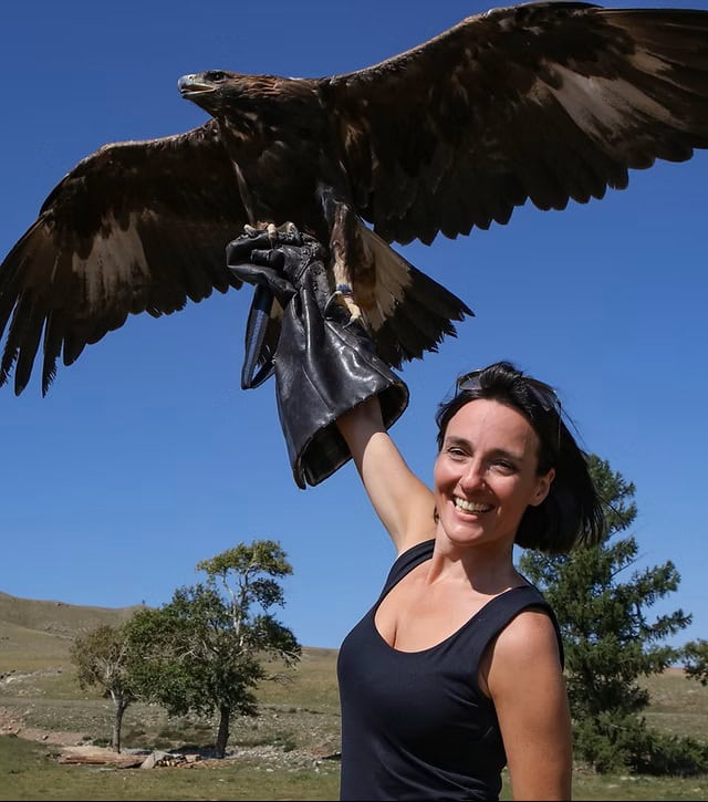 Sonja Piontek holding a golden eagle outdoors